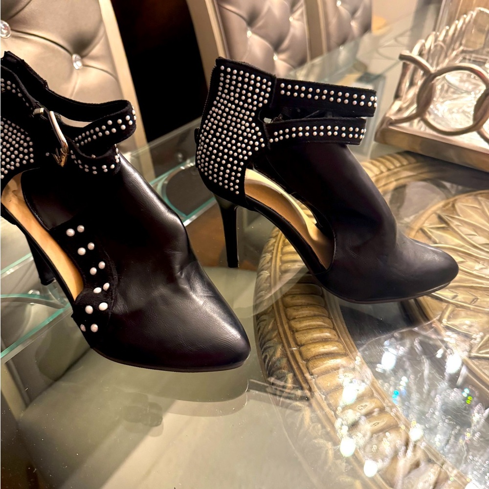 A pair of black  shoes with small studs.